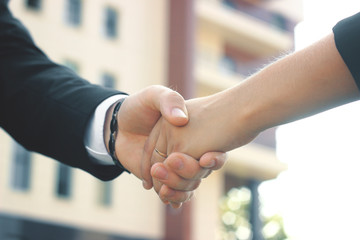 close up. the handshake business partners in the outdoors.photo with copy space.