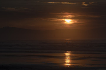 silhouettes on the beach at sunset
