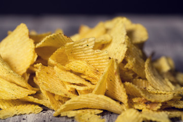 A lot of chips lie on the table, not a healthy diet and harmful food