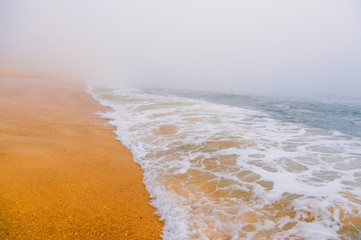 Picturesque scenery seascape of foggy misty abandoned wild beach. Art beautiful landscape of deserted cost with ocean waves. Colorful nature paysage. Desolate mediterranean coastline. Fairy tale view.