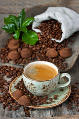 Chocolate truffles and cup of aromatic coffee