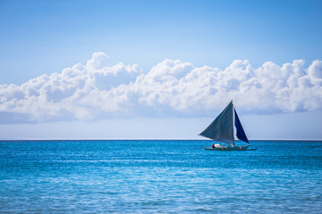 One double outrigger sailboat on the sea © Filipe Lopes