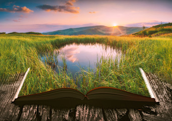 Mountain lake on the pages of an open book