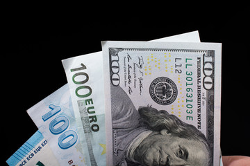 Hand holding American dollar  isolated on black background
