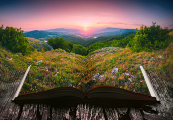 Sunset in a valley on the pages of an open book