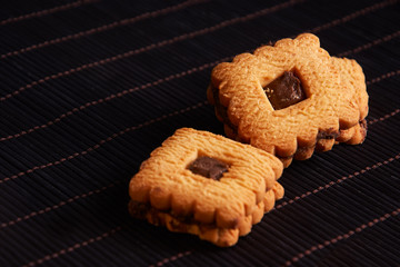 Warm Homemade Gingersnap Cookies topped with chocolate on red style background
