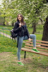 Glamorous young caucasian woman in black leather jacket