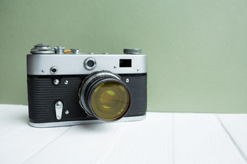 Retro camera on a green background