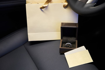 Diamond jewelry rings and earrings in the salon of a luxury car, a gift for women. Empty cards and shopping bag with copy space for your text