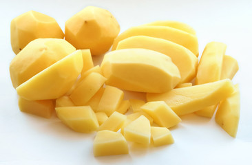 Cut potatoes into slices. Cut raw potatoes for soup. Cut fresh potatoes for cooking.