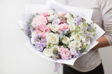 bouquet of beautiful flowers in women's hands. Floristry concept. Spring colors. the work of the florist at a flower shop. Horizontal photo