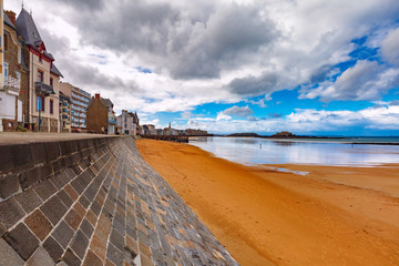High stone embankment and beach at low tide, in beautiful walled port city of Privateers...