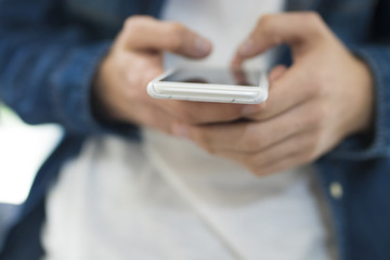 young hands with a mobile phone in the foreground
