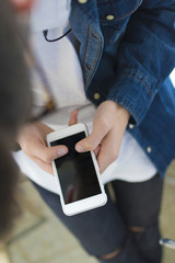 young hands with a mobile phone in the foreground