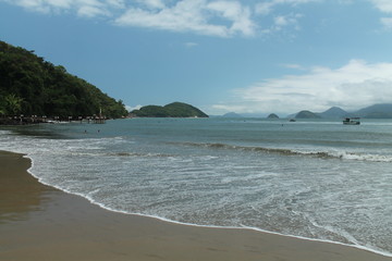 Praia da Barra Seca, Ubatuba, Sao Paulo, Brazil - Paradise tropical beach with white sand, blue and calm waters, without people on a sunny day and blue sky of the Brazilian coast in high resolution