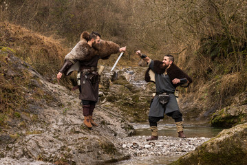 Two viking warriors duel with the sword