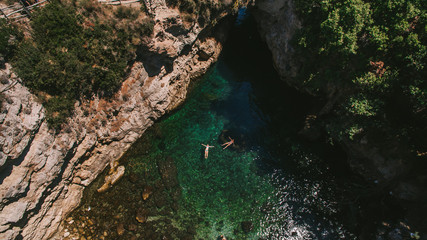 two people in green bay in capri island italy inside cave view