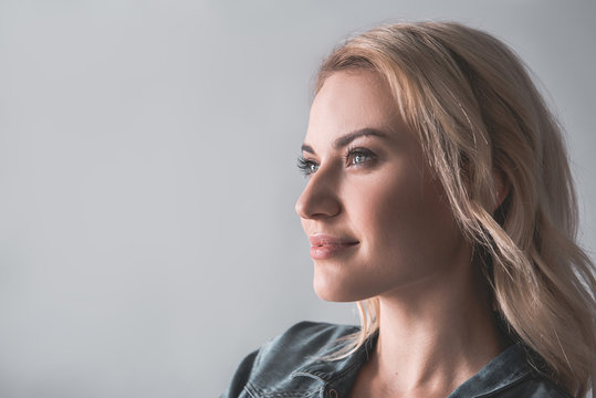 Profile Of Pensive Woman With Blonde Hair Looking Aside. Copy Space In Left Side. Isolated On Background