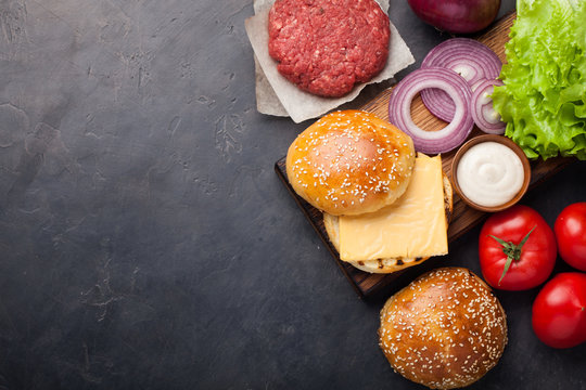 Hamburger Building Kit. Fresh Ingredients For Burger On Dark Stone Table. Top View With Copy Space