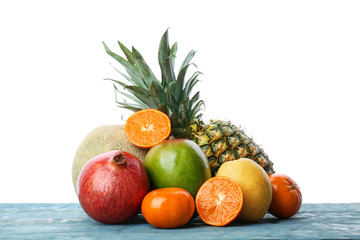 Set of fresh tropical fruits on wooden table