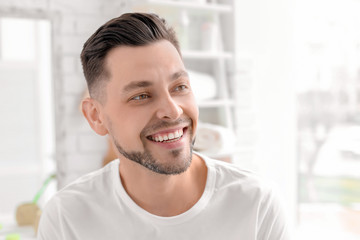 Young man with beautiful smile indoors. Teeth whitening