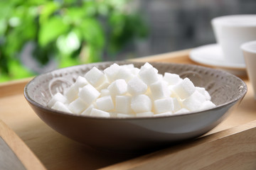 Fototapeta na wymiar Bowl with refined sugar on table