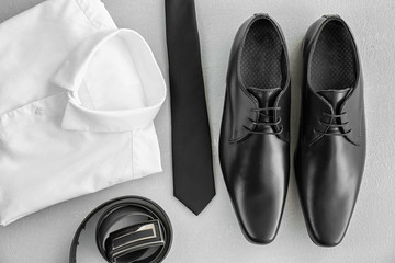 Composition with elegant male shoes and accessories on light background