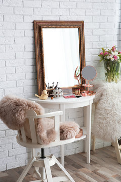 Beautiful mirror on table in modern makeup room