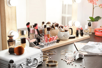 Table with cosmetics in modern makeup room