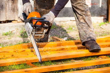 the builder saws the chainsaw