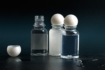 Shampoo and shower gel. Dark background.