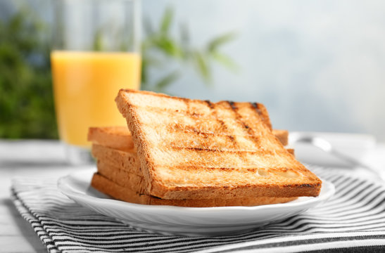 Plate With Toasted Bread On Table