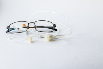 glasses and medical dropper over white background