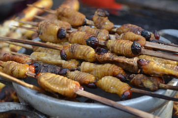 Suri - an Amazonian grub that feeds on palm sap, grilled and served as a snack food in Iquitos, Peru