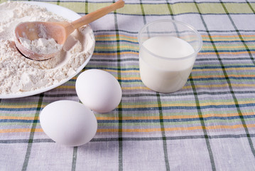 Milk, eggs and flour on the table