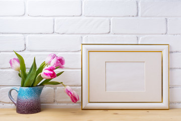 Gold decorated landscape frame mockup with magenta tulips