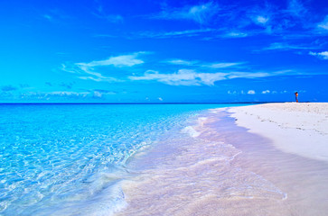 真夏の宮古島。与那覇前浜ビーチの風景と写真撮影をする男性
