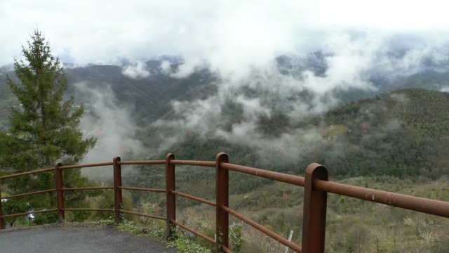 Early foggy morning in the Alps. Fog from the mountains falls into the valley. Perinaldo, Italy.