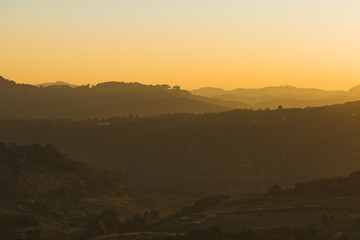 Golden sky with sunlight and the Mountains in sunset.