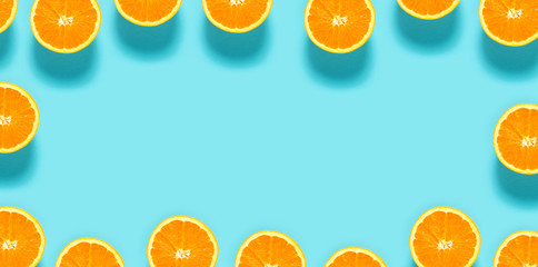 Fresh orange halves on a blue background