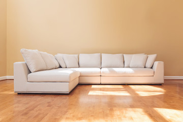 White sectional couch in a large luxury interior home