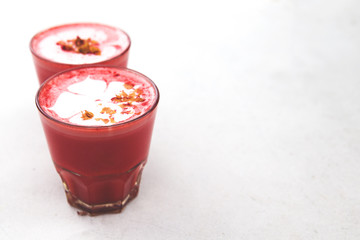Two Beetroot super latte on marble background.