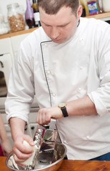 Food and people concept: male chef with cooked food standing in the kitchen.