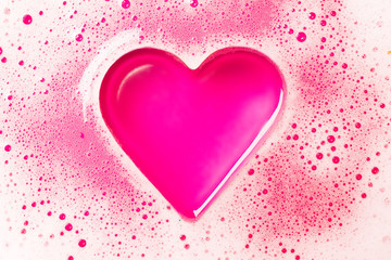 Heart from a foam on a pink background.