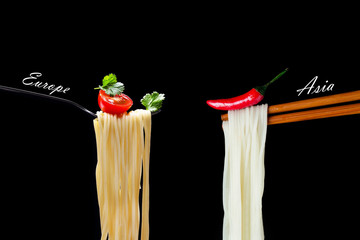 Hot spagetti on the fork with tomato and parsley and Asian noodles on chopsticks with red pepper.