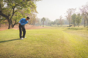 Fototapeta premium Man playing golf on a golf course.