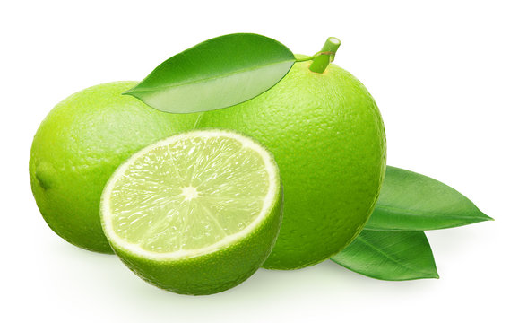 Fresh lime fruit next to lying, half and green leaves