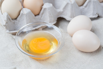 Fresh farm eggs. Egg yolk in glass bowl.