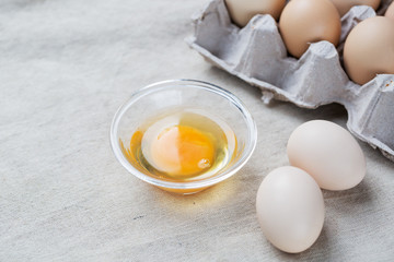 Fresh farm eggs. Egg yolk in glass bowl.