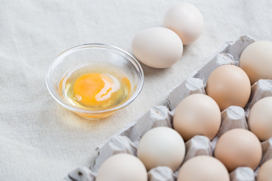 Fresh farm eggs. Egg yolk in glass bowl.